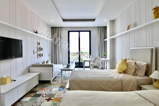 Two single beds inside studio apartment