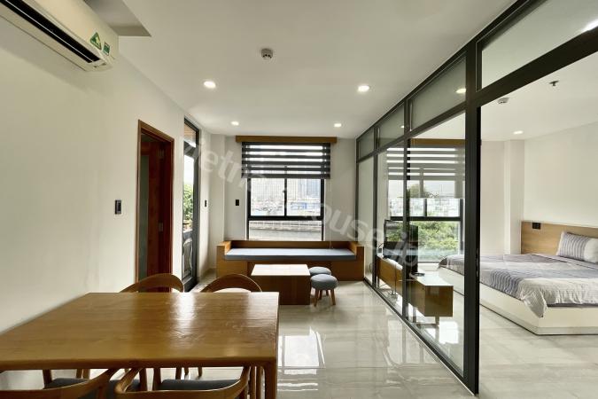 Sun-drenched serviced apartment with large glass windows and vibrant Metro view in Binh Thanh